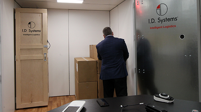 An MCE attendee in the I.D. Systems booth. (John Sommers II for Transport Topics)