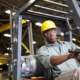 African American worker driving forklift
