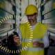 Man on phone monitoring the use of machines in operation